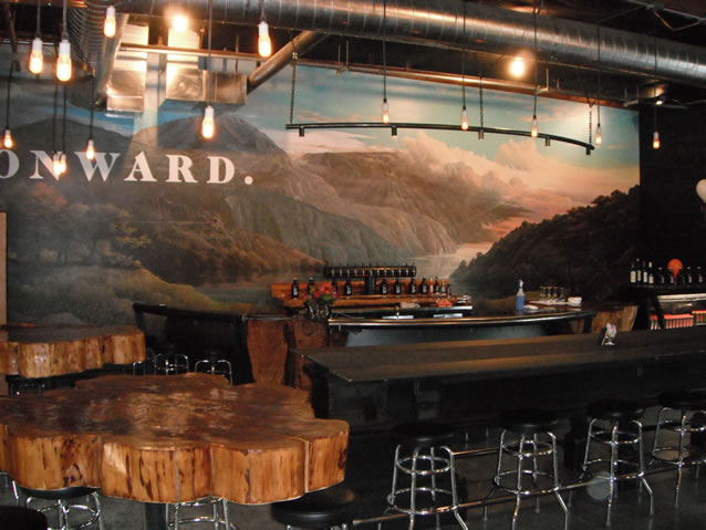 Skybound Distillery's tasting room has a fantastic Northwest design including a massive Northwest painted mural on the bar's back wall and tables made out of huge red cedar tree trunks. Great place to have a company function, friend's get-together, or just come and taste their spirits.