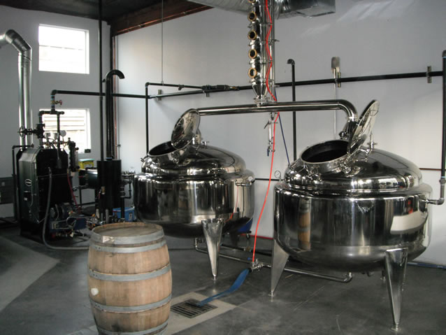 Dragon still installed and ready to start making spirits. At left, Columbia Boiler MPH-10 natural gas boiler system installed with steam lines.