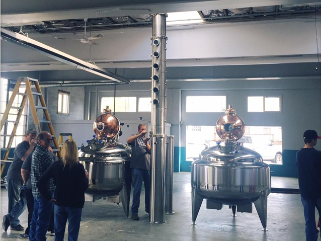 Installing our stars of the show - Figgins stills!! Two 250-gallon steam-jacketed stainless steel tanks.