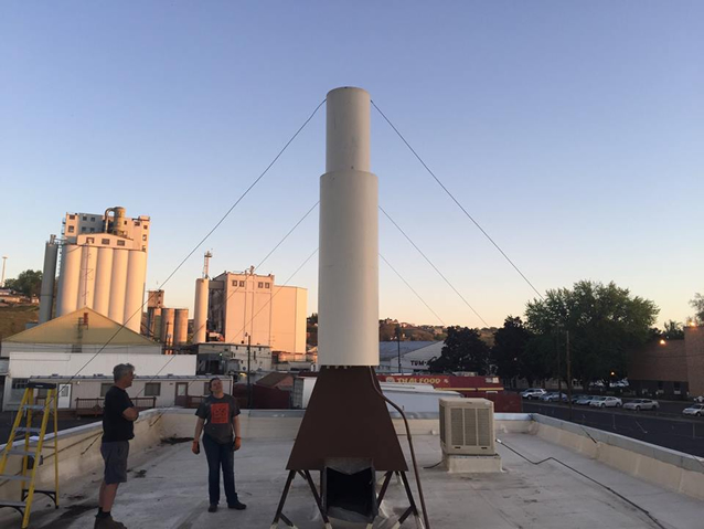 The single, 2' wide stainless steel cooling tower for the two tanks after being updated to match the building.
