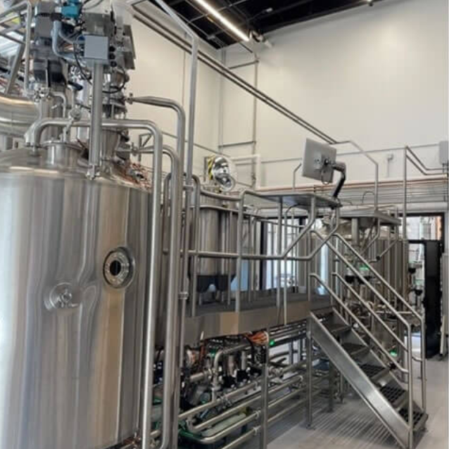 Stainless steel brewing kettles in the brew house.