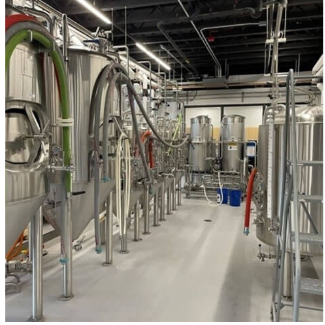 Stainless steel fermenting tanks in the brew house.