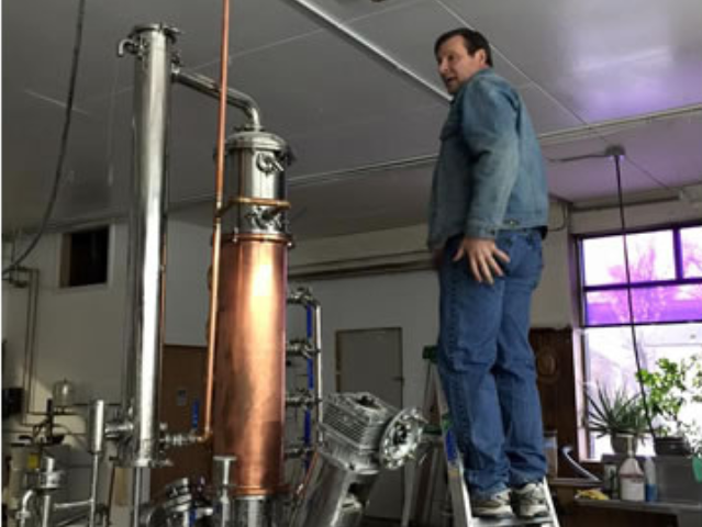 Scott Wagner, known officially as "Booze Nerd", setting up their new still.