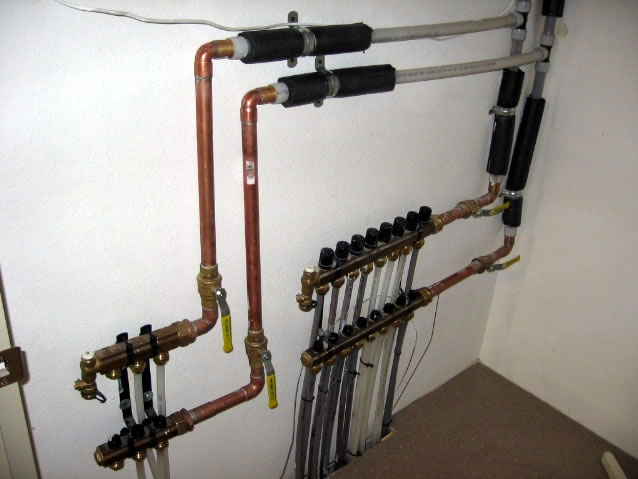 Hydronic manifolds used to disburse hot water to heating units.