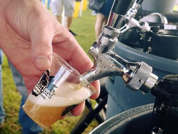 Pouring Guava Wheat beer at Grovetoberfest, one of many festivals Unbranded Brewing supports.