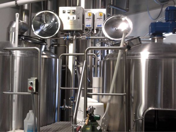 The brewhouse, left to right: brew kettle, hot liquor tank, and mash turn.