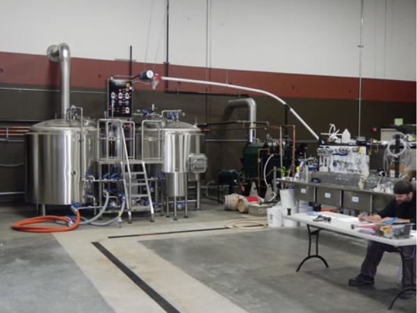 Sumerian Brewery's brew house including mash tanks and low pressure steam boiler.