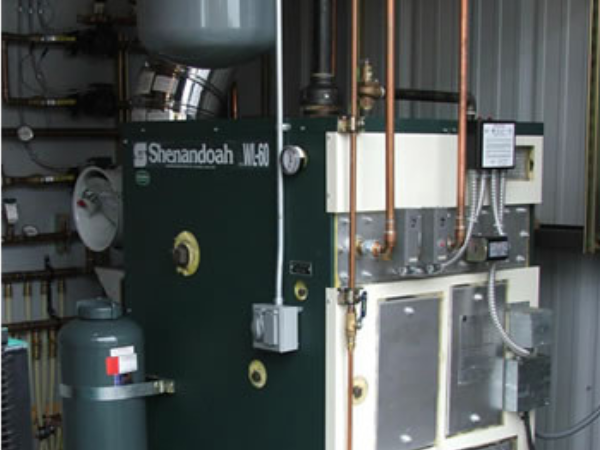 Columbia/Shenandoah WL-60 waste/used oil fired boiler to heat water for the radiant floor system.