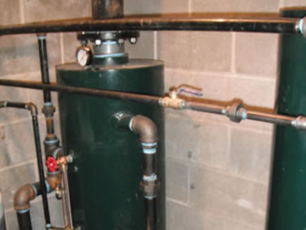 Vertical blow down tank. Along with the water feed system these two automate important boiler functions for decades of reliable low pressure steam heat.