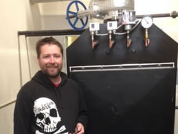 Three cheers for Head Brewer Tyson Reed! Tyson is standing next to their Columbia MPH 100 boiler. This boiler provides the low pressure steam for their production brewery.