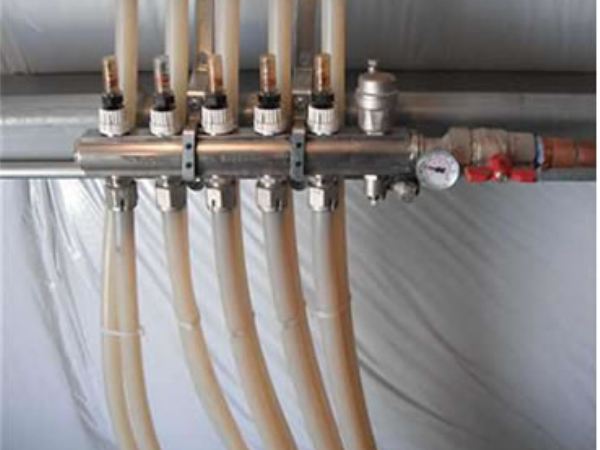 Nickel plated brass manifolds with integrated flow meters, balancing valves, and air vents.