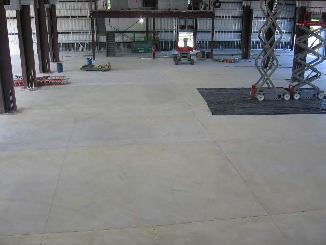 Pouring concrete over PEX tubing.