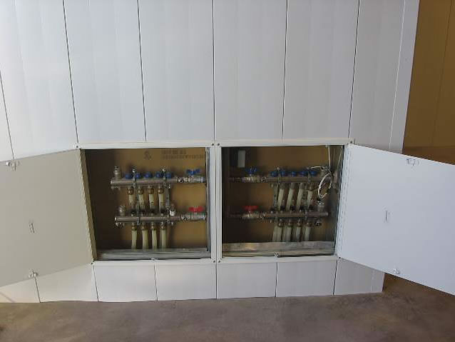 Wall access panels for radiant floor heat manifolds.