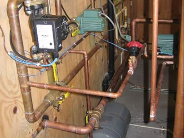 Boiler piping to radiant floor pumps and controls.