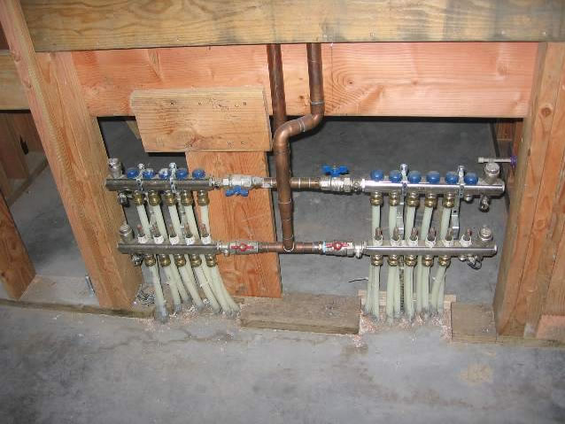 Wall roughed in around radiant floor heat manifolds.